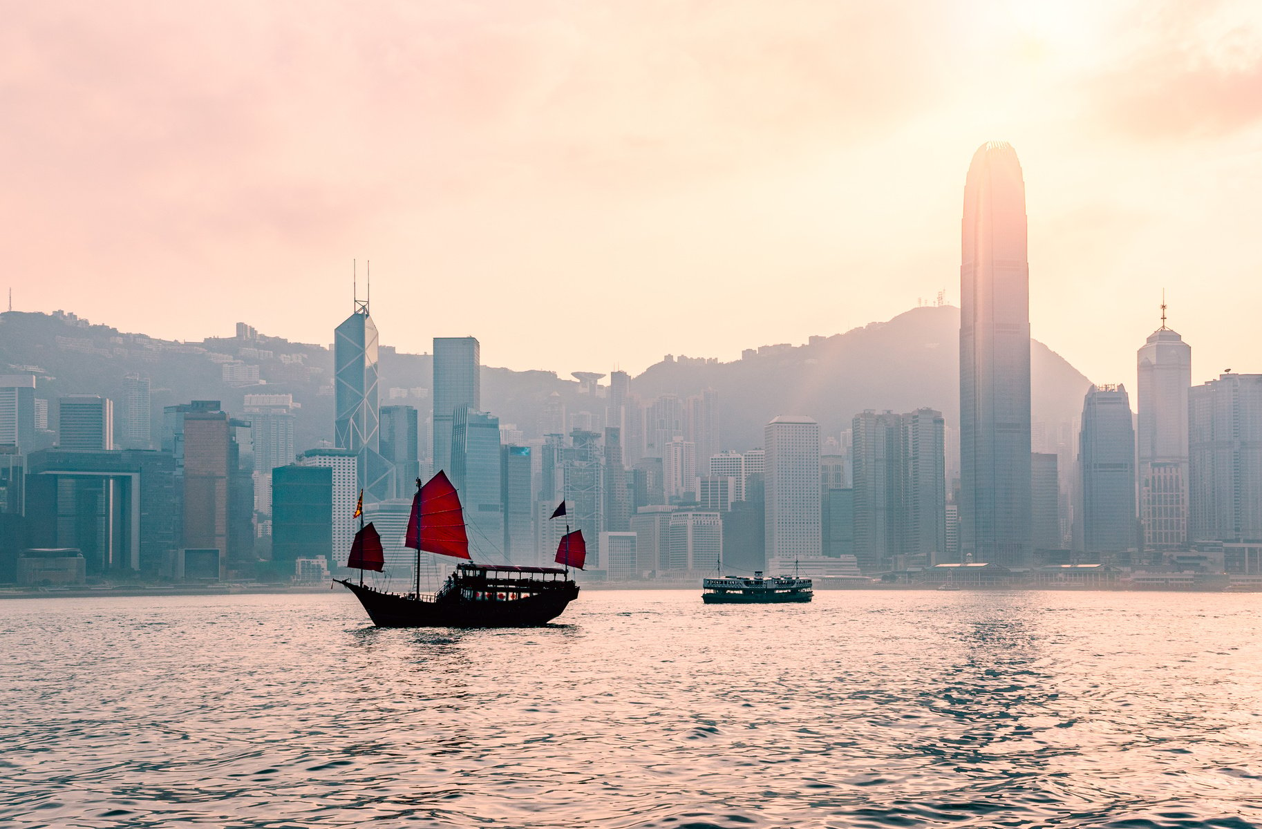 Junk boat in Hong Kong at Victoria harbour in the evening